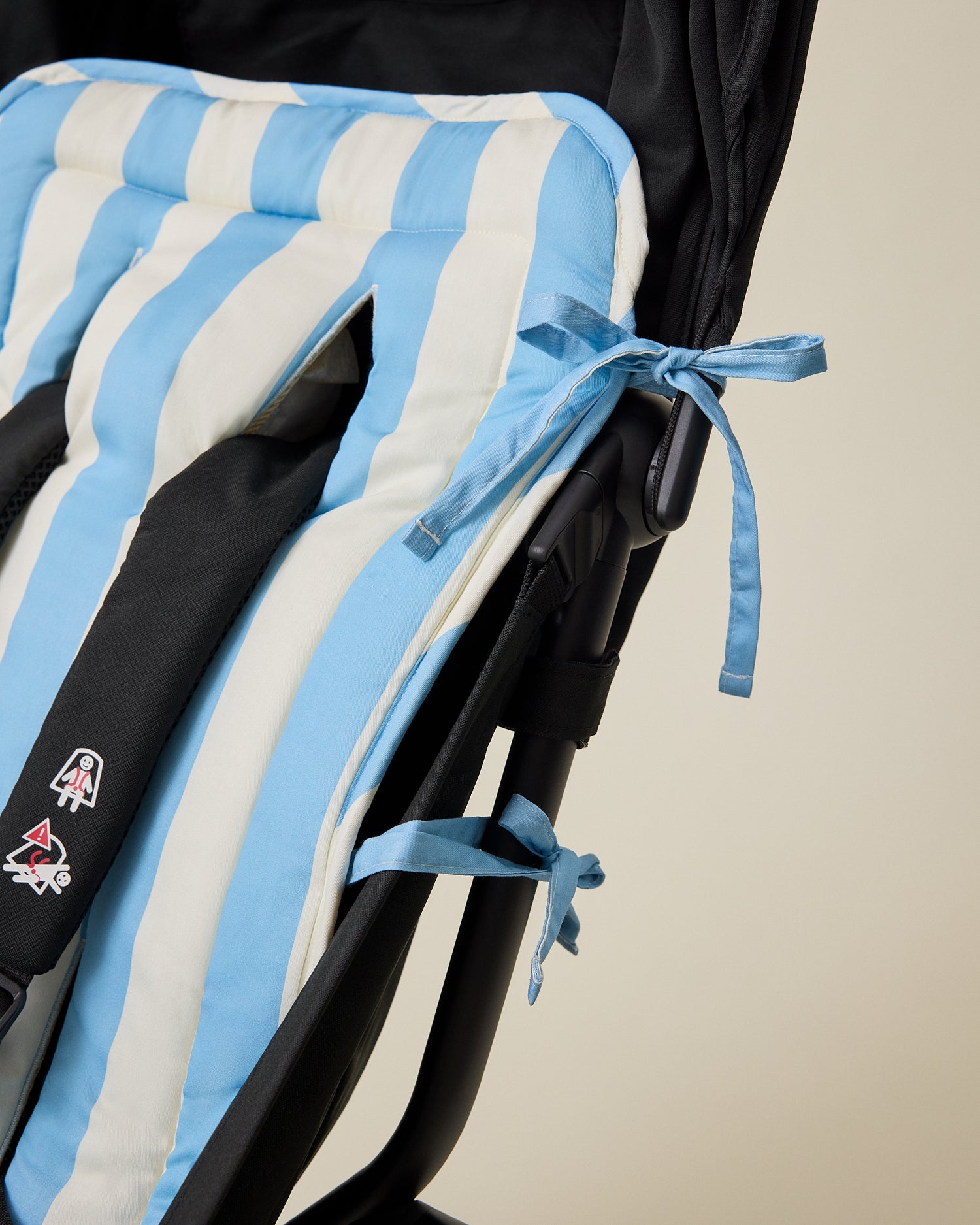 Close-up of ties on Stroller Party Seat Liner in Blue Wide Stripe pattern on stroller