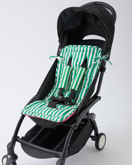 Black stroller with Stroller Party™ Seat Liner in Green Stripe and Stroller Party™ Seat Liner & Strap Covers in Green Stripe on a beige background.
