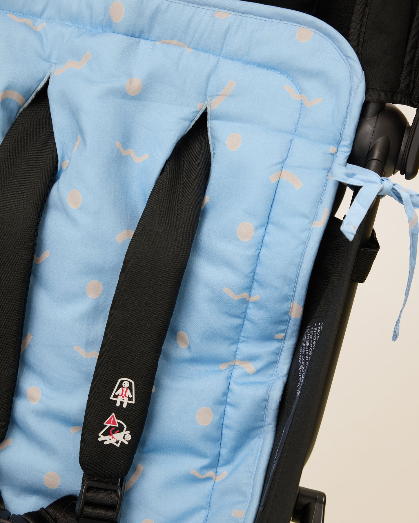Close up of Stroller Party Seat Liner in Sky Squiggles on a stroller