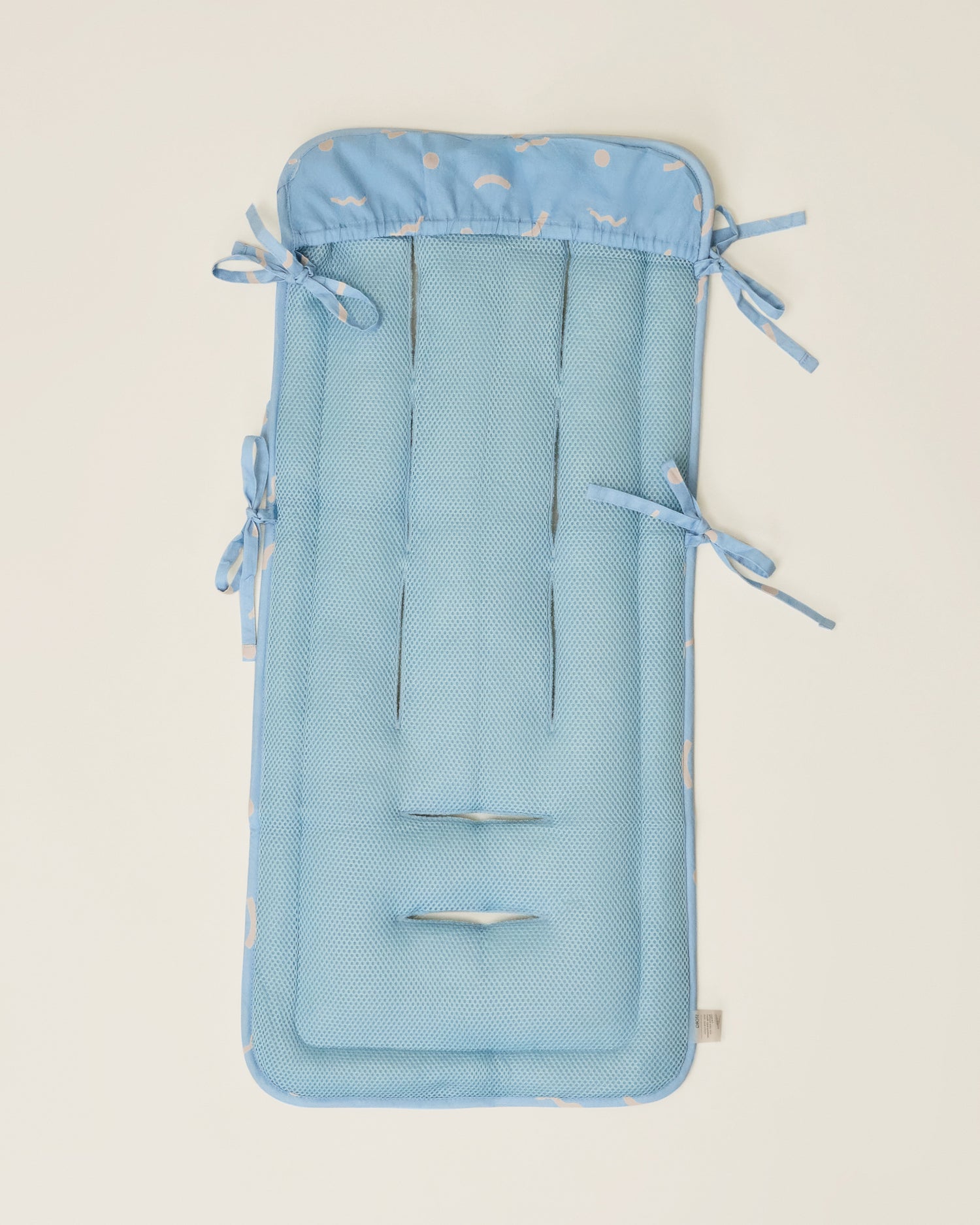 Stroller Party Seat Liner in Sky Squiggles on a neutral background, showing the back of the seat liner
