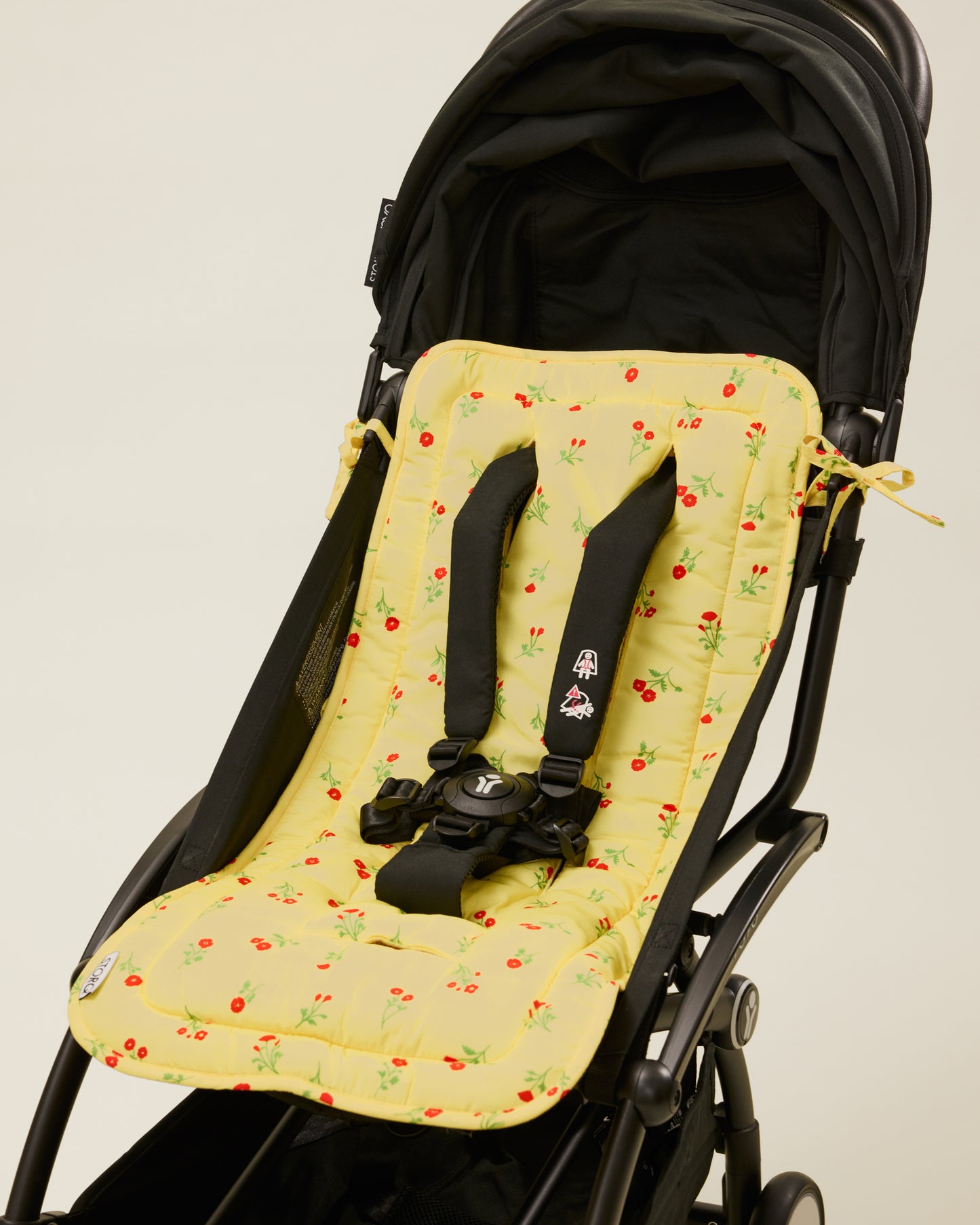 Stroller Party Seat Liner in Sunshine Wildflower placed on a stroller
