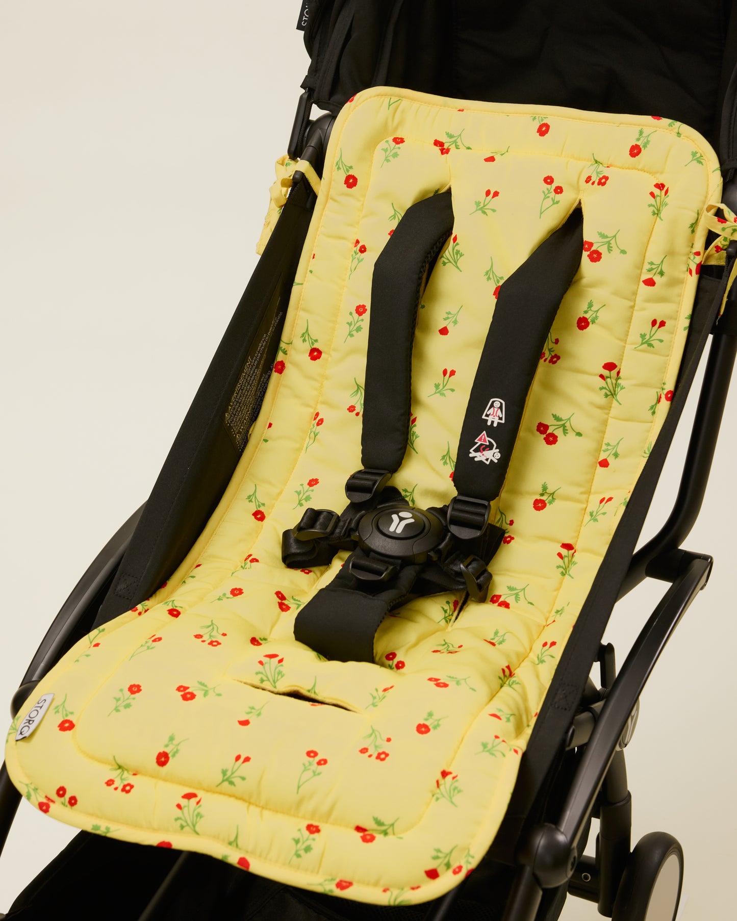 Stroller Party Seat Liner in Sunshine Wildflower placed on a stroller