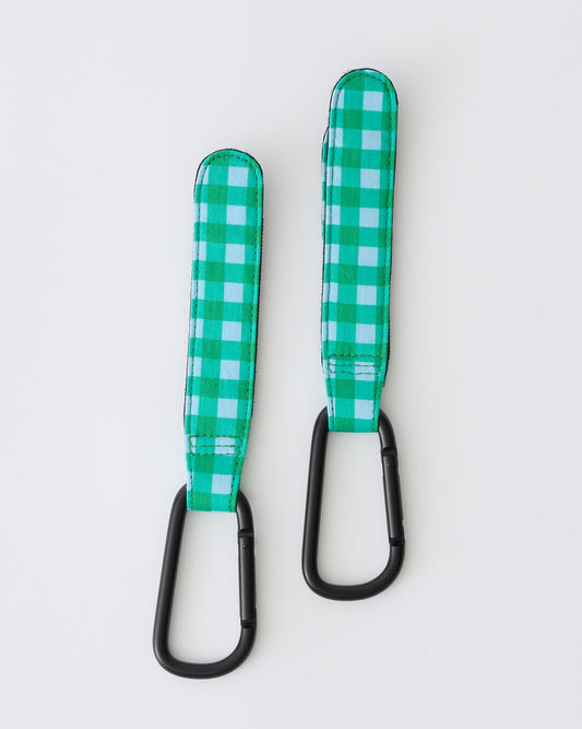 Stroller Party™ Clips (2-Pack) in Teal Gingham on a beige background.