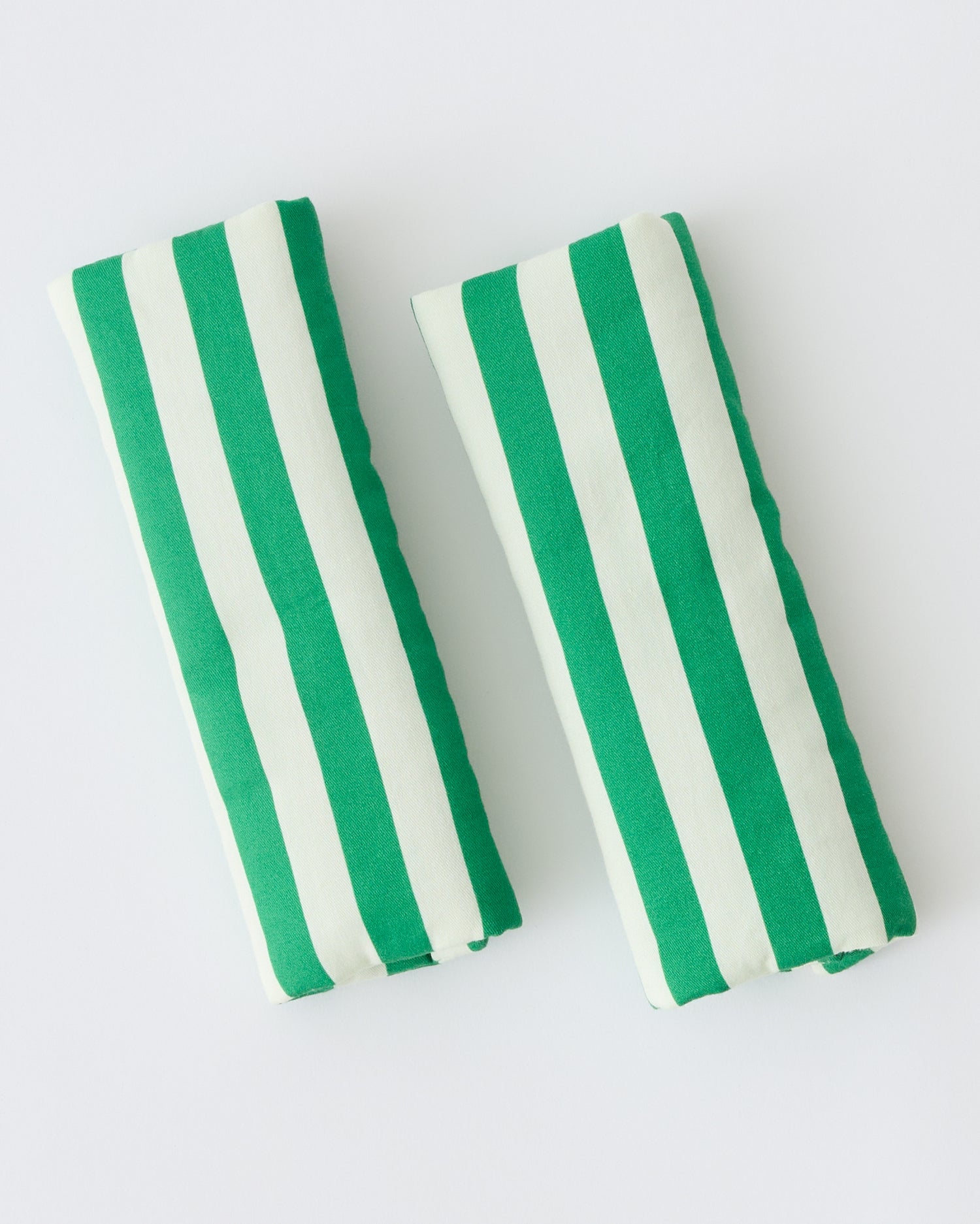 Folded Stroller Party™ Seat Liner & Strap Covers in Green Stripe on a beige background.