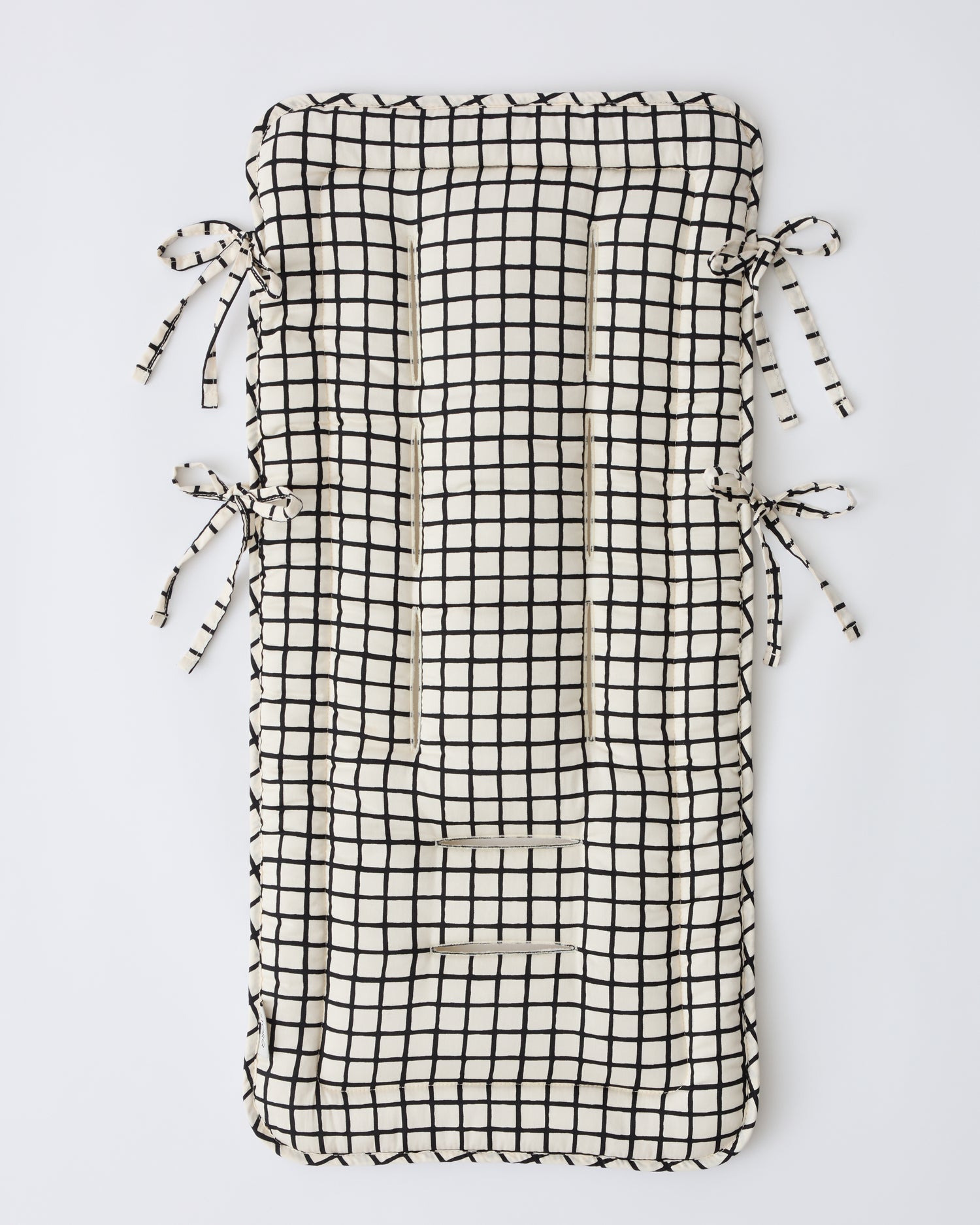 Stroller Party™ Seat Liner in Black Grid on a beige background.
