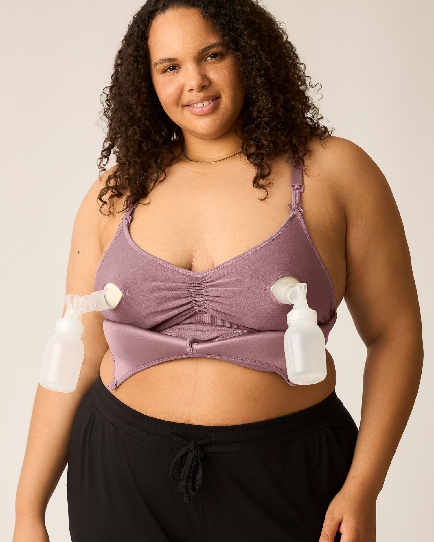 Woman wearing the Signature Sublime® Contour Hands-Free Pumping & Nursing Bra in Twilight with two pump flanges inserted