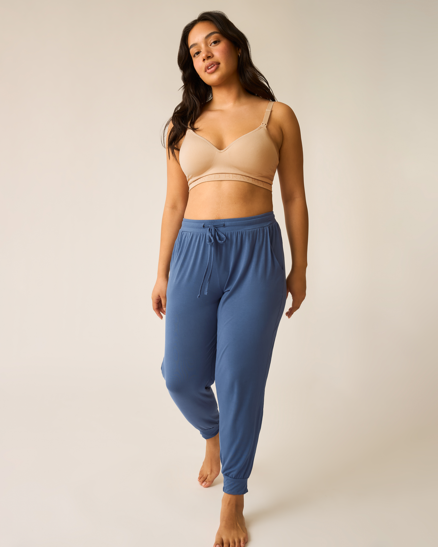 Woman wearing the Everyday Lounge Jogger in Slate Blue with beige Contour bra.