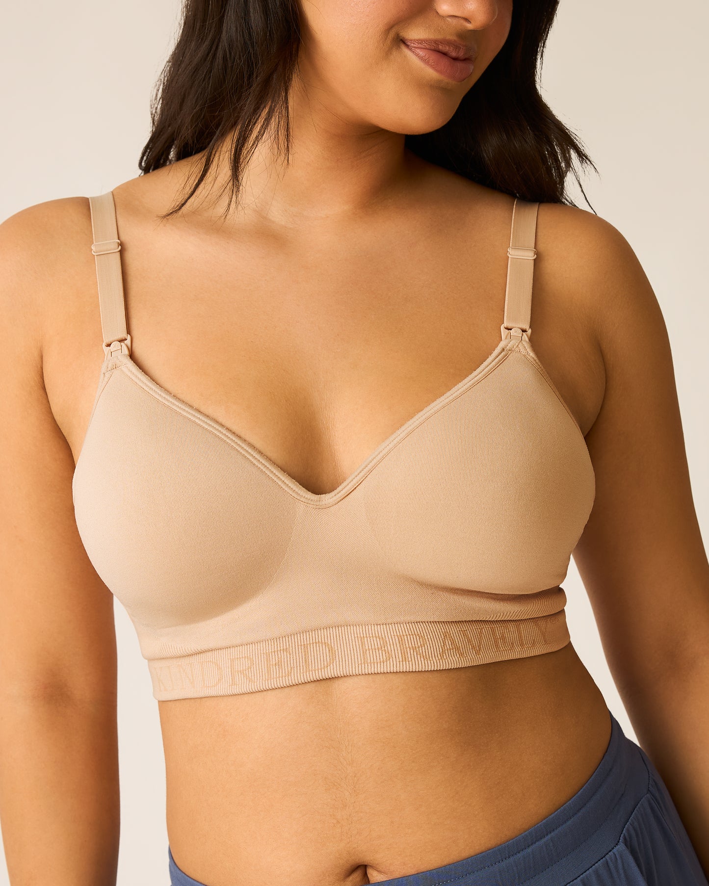 Woman wearing the beige Signature Sublime® Contour Hands-Free Pumping & Nursing Bra against a neutral background