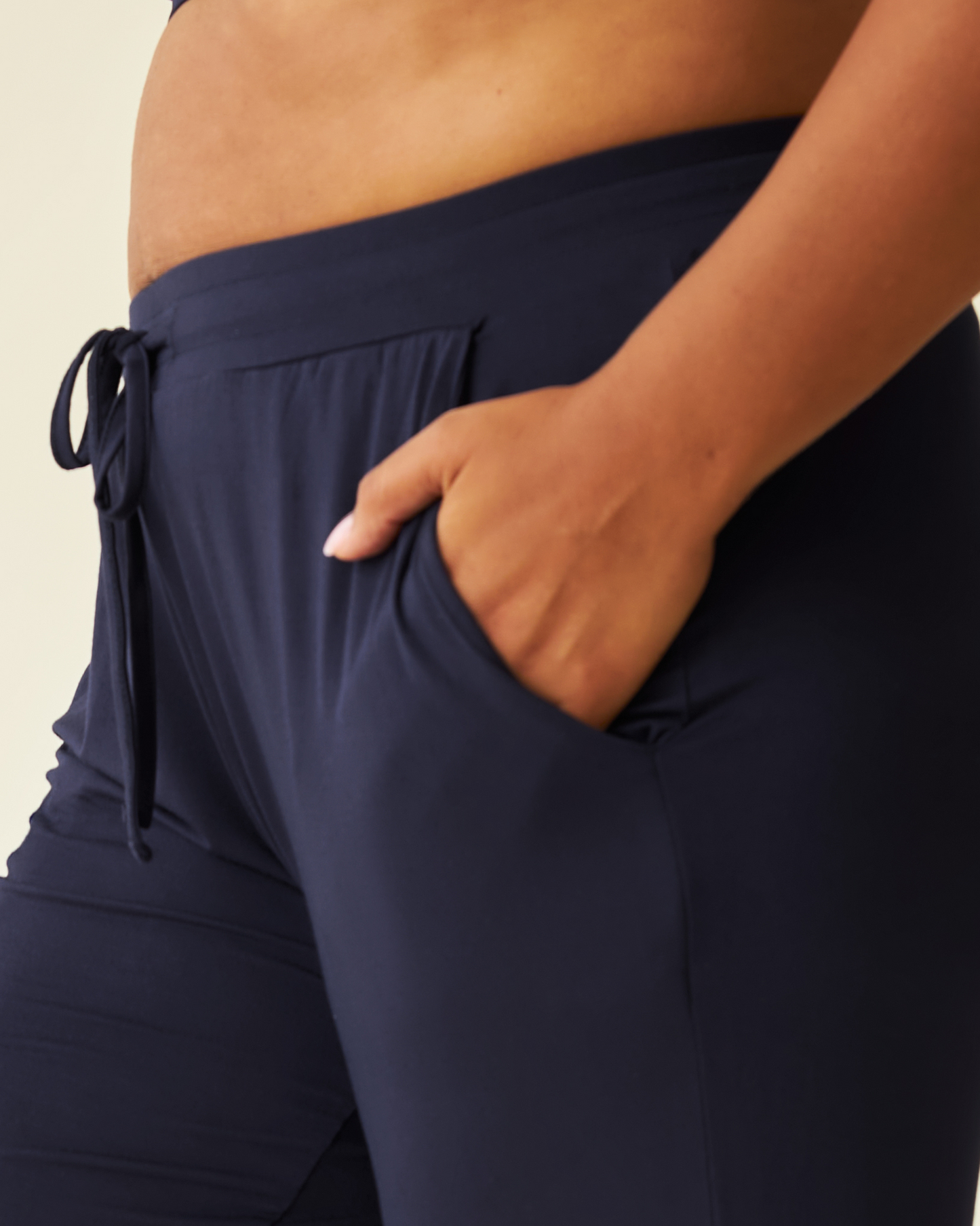 Close-up of pregnant model wearing the Everyday Lounge Jogger in Navy