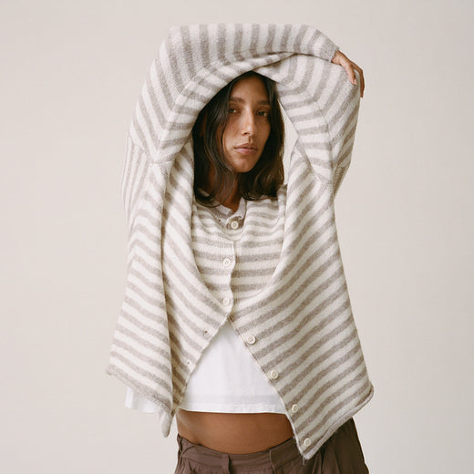 Model is wearing Ultra Soft Maternity & Postpartum Cardigan in Tan & White Stripe, Maternity & Postpartum Wide Leg Trouser in Brown and a nursing white tee, on a beige background.