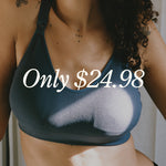White text over image reads: Only $24.98. Image of model wearing Mia Maternity & Nursing Lounge Bra in Light Navy in light filled room with curtains behind her and light cast across Bra.