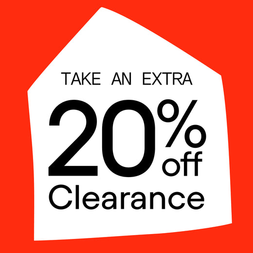 A promotional sale graphic with a bright red background, a white house-shaped outline, and large black text reading 'TAKE AN EXTRA 20% off Clearance.' 