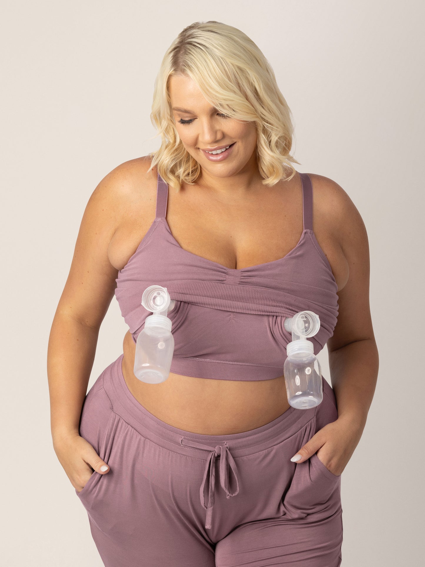 Model wearing the Sublime® Bamboo Hands-Free Pumping Lounge & Sleep Bra in twilight with two pump flanges and bottles