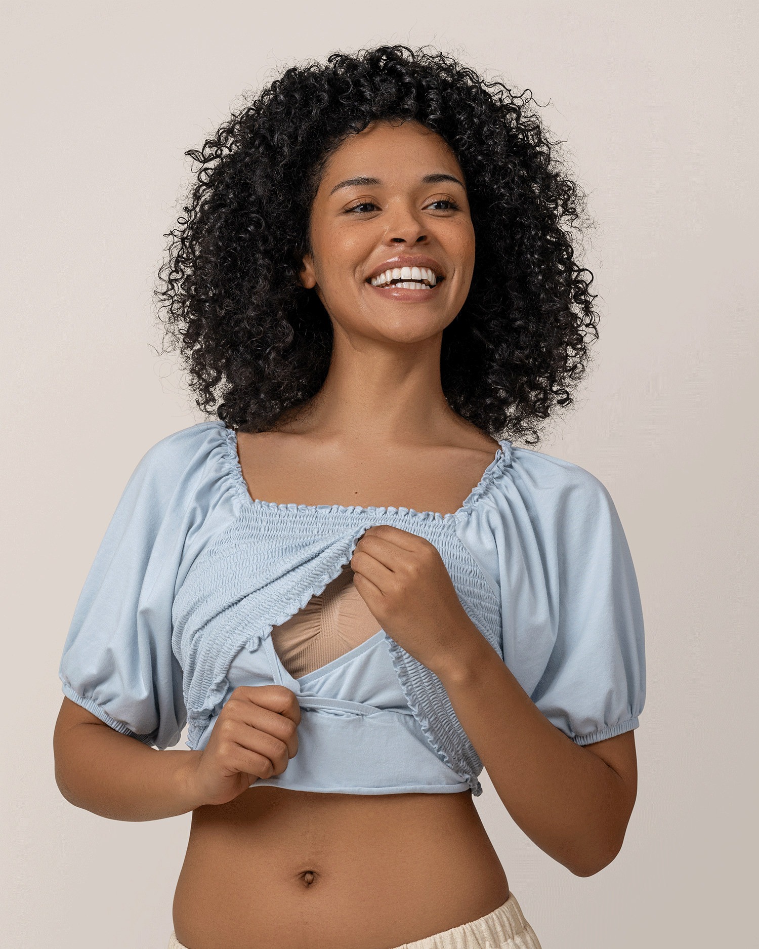Front view of model wearing Sophia Smocked Cropped Nursing Top in French Blue, showing nursing access