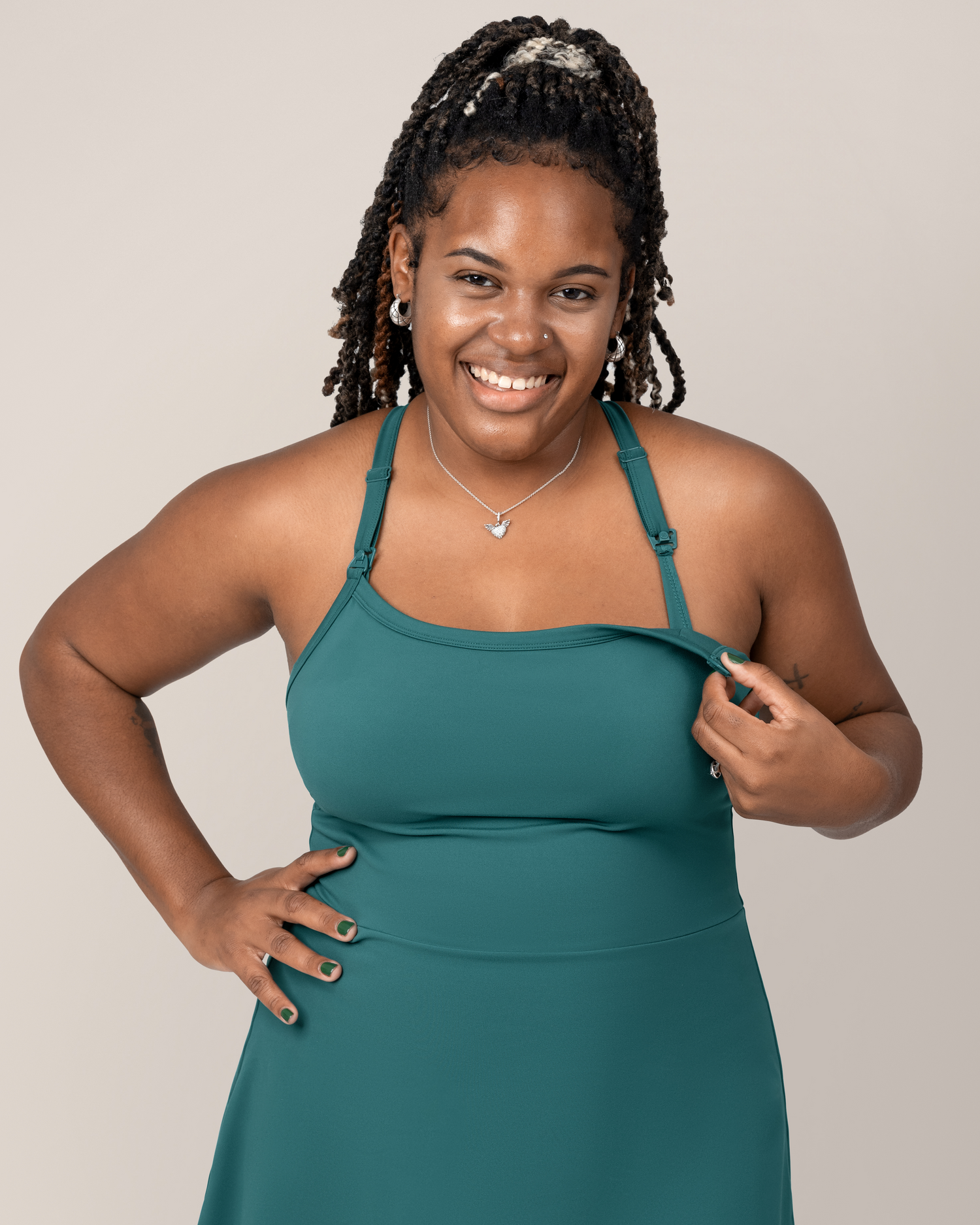 Front cropped in view of model wearing the Stevie Active Racerback Nursing Dress in Teal showing unclipping nursing access
