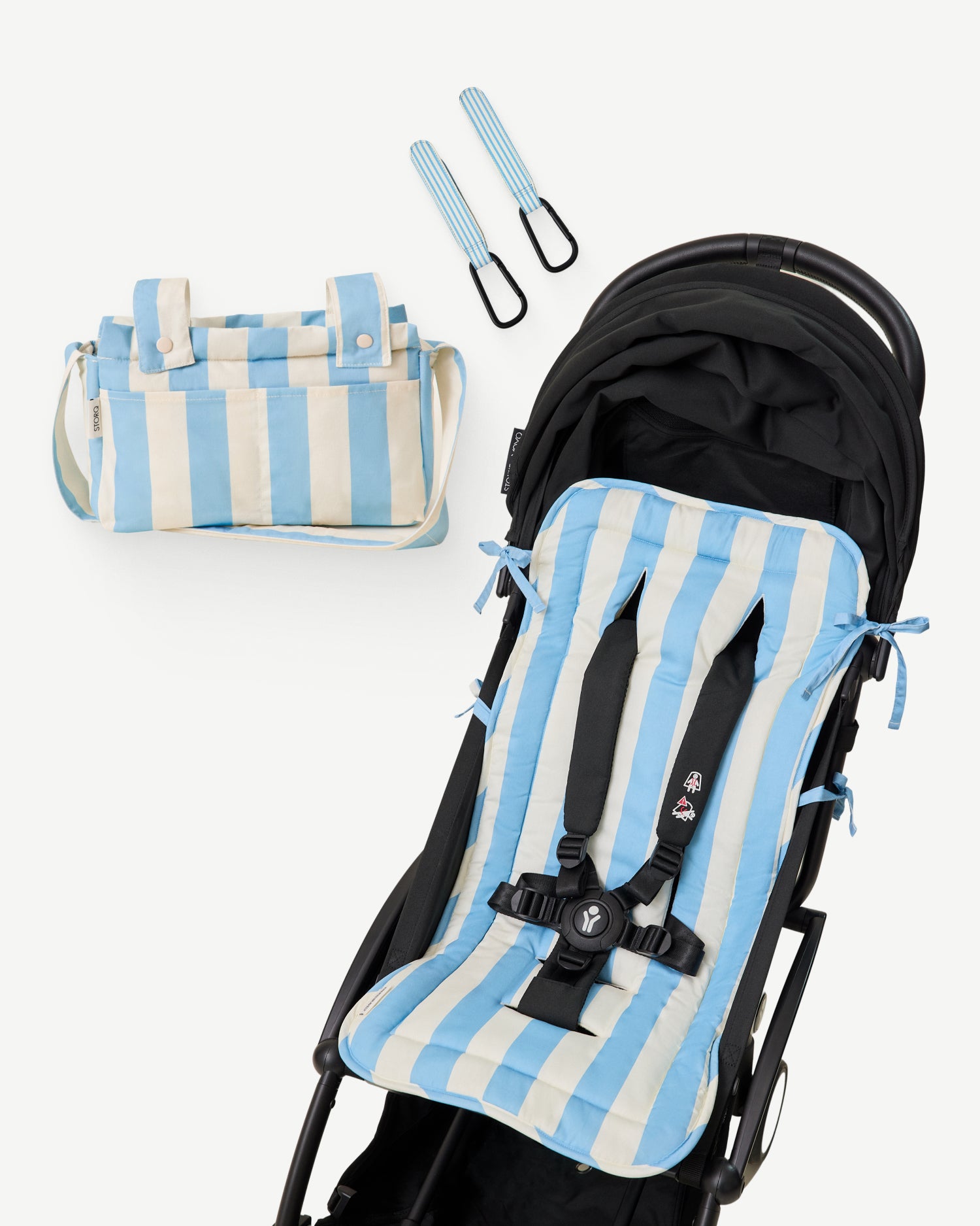 The Stroller Party Seat Liner, Stroller Party Clips (Two-Pack), and the Stroller Party Caddy Bag of the Stroller Party Set in Blue Wide Stripe on a white background