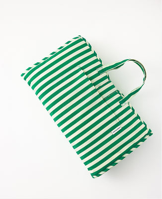 Nap Mat in Green Stripe, easily folded to display pocket for lovey and ready to go, on a white background.