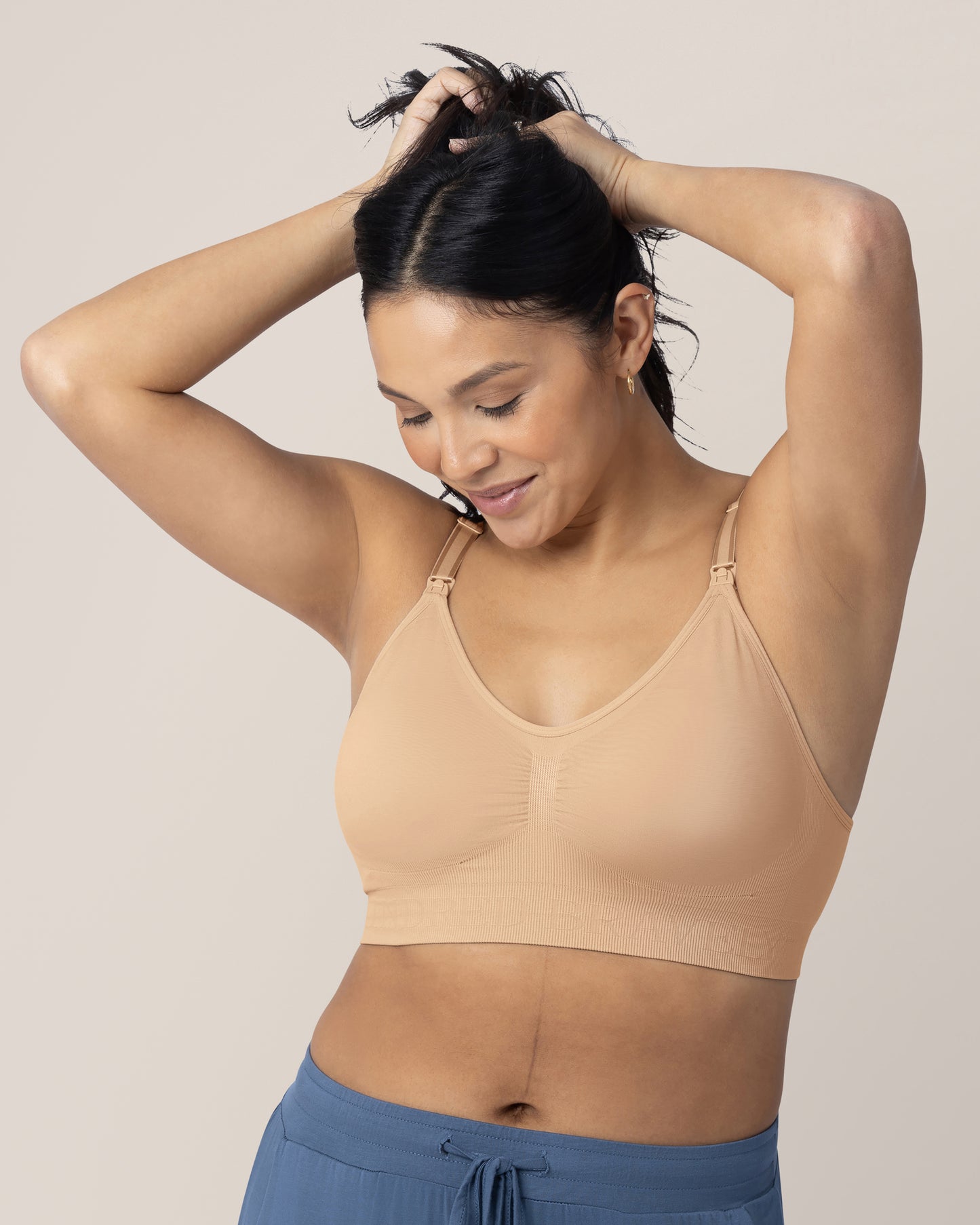 Model wearing the Simply Sublime® Nursing Bra in Beige with her hands in her hair.  @model_info:Julana is wearing a Small.