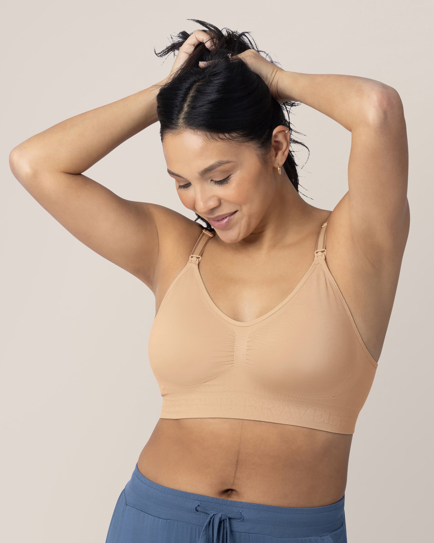 Model wearing the Simply Sublime® Nursing Bra in Beige with her hands in her hair.  @model_info:Julana is wearing a Small.