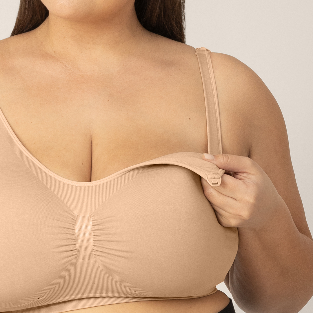 Zoomed in image of Super Busty model wearing the Sublime Nursing Bra in Beige, unclipped showing nursing capabilities.