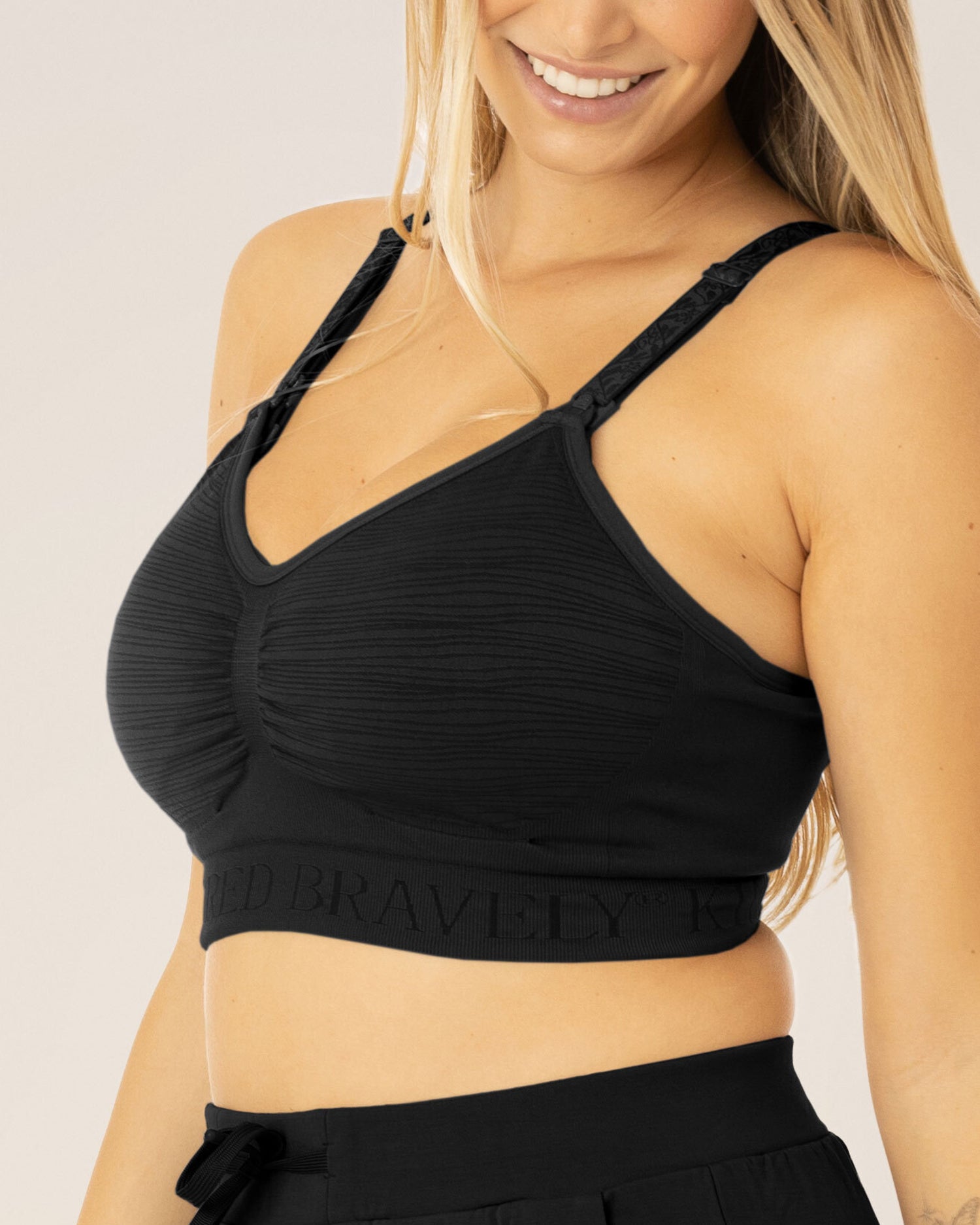 Woman wearing the Sublime® Hands-Free Pumping & Nursing Bra in Black @model_info:Raine is wearing a Small Busty.