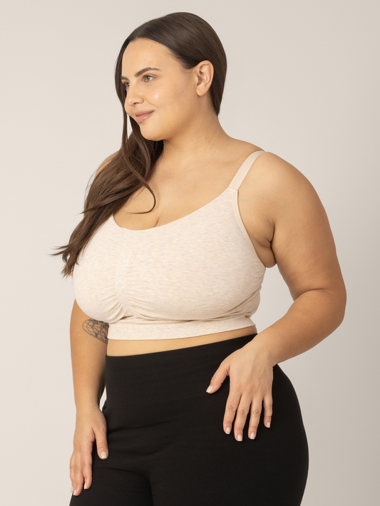 Side view of Super busty model wearing the Sublime Hands-Free Pumping & Nursing Sleep and Lounge Bra in Oatmeal Heather. @model_info:Anna is wearing a Large Super Busty.