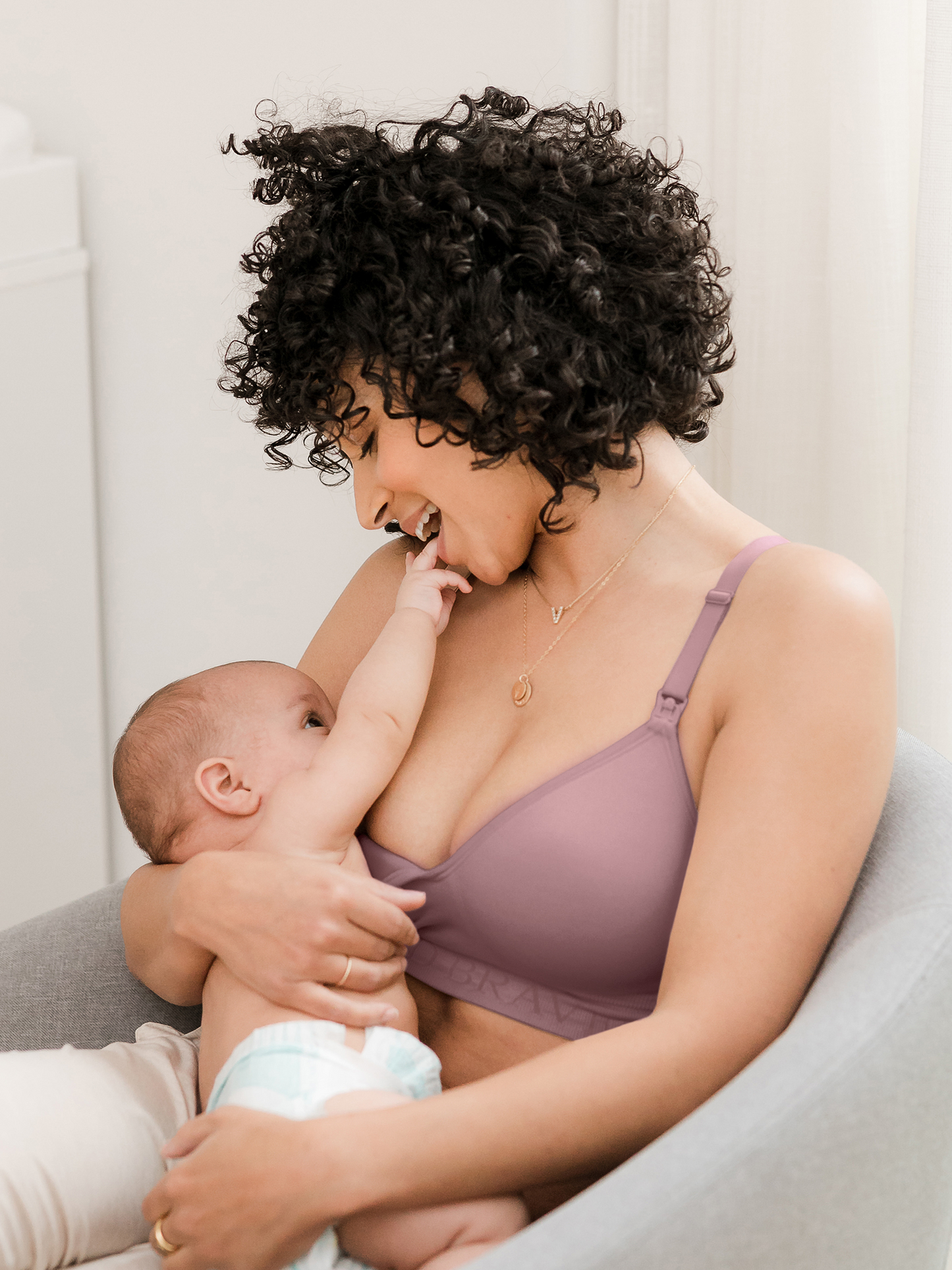 Model breastfeeding her baby while wearing the Signature Sublime® Contour Maternity & Nursing Bra in Twilight