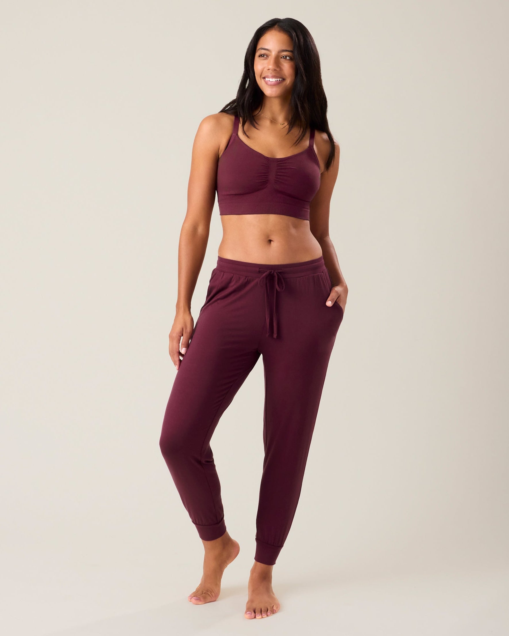 Woman wearing the Everyday Lounge Jogger in deep burgundy paired with matching bra