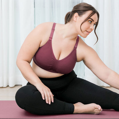 Model doing yoga while wearing the Sublime® Hands-Free Pumping & Nursing Sports Bra in Fig.