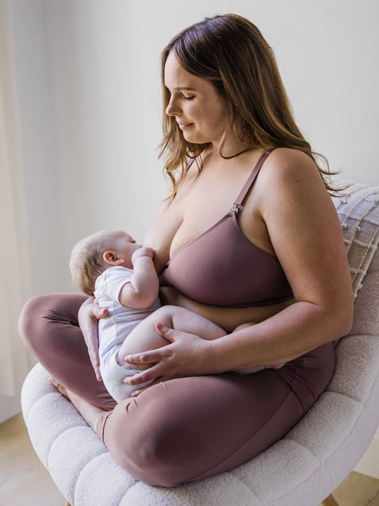 Model wearing the Signature Sublime® Contour Maternity & Nursing Bra in Twilight and breastfeeding her baby. 