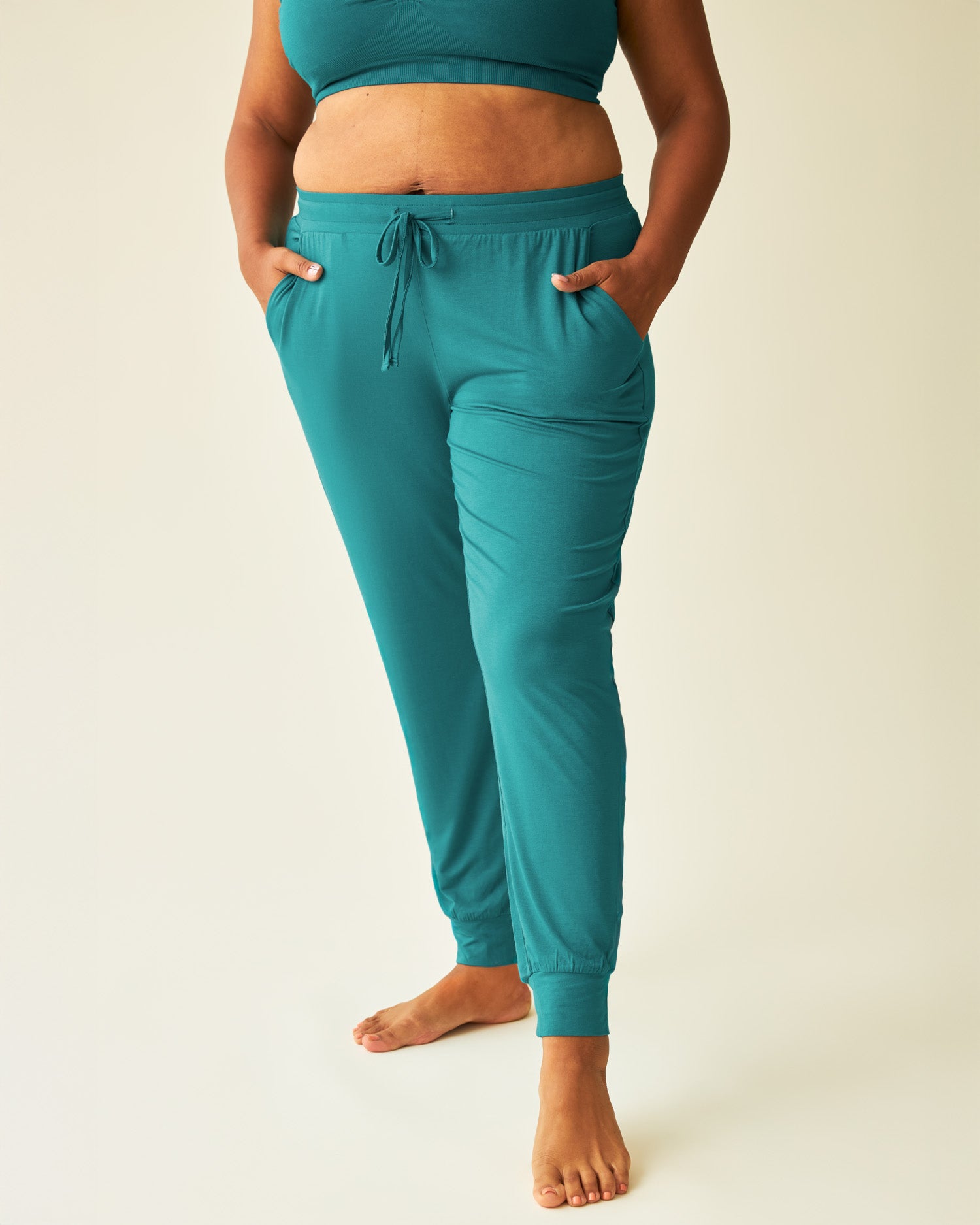 Model with hands in pockets, wearing the Everyday Lounge Jogger in Bright Teal