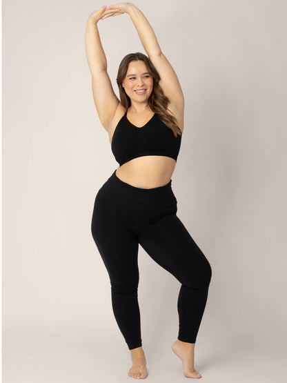 Model wearing the Sublime® Nursing Sports Bra in Black with her hands above her head.