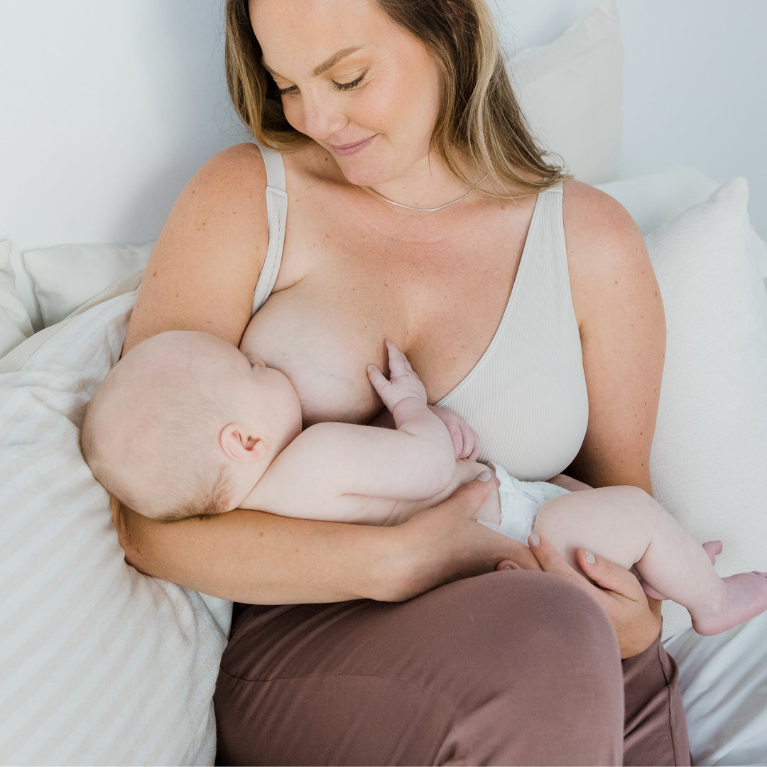 Busty Mom wearing the Adjustable Crossover Bra and feeding her baby