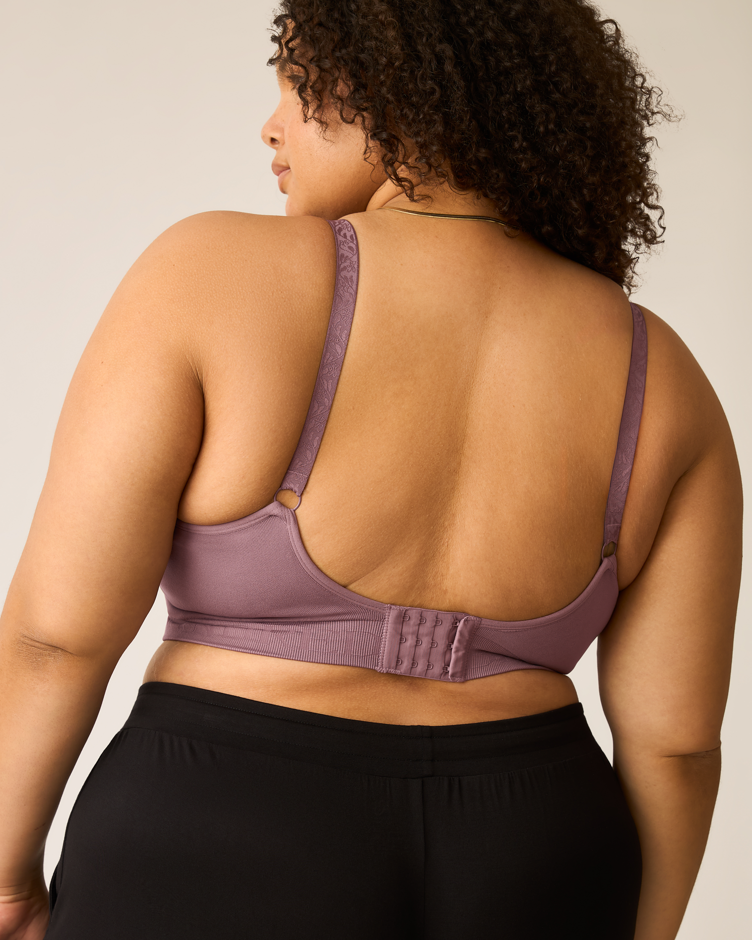 Woman wearing the Sublime® Hands-Free Pumping & Nursing Bra in Twilight against a plain background
