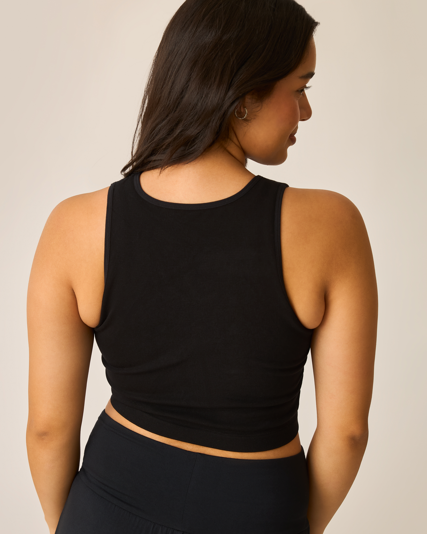 Person wearing the Sublime® Bamboo Hands-Free Pumping Longline Bra Top in black against a neutral background