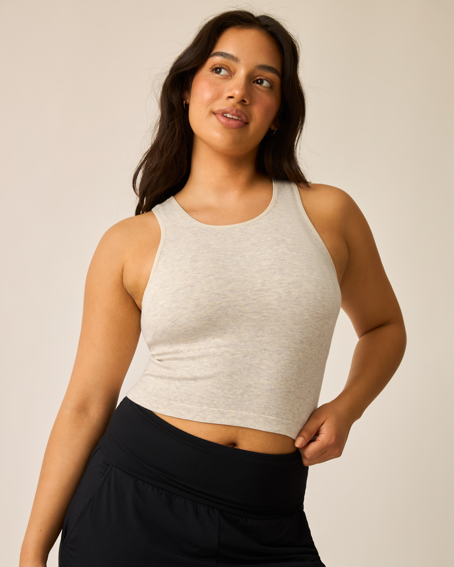 Woman wearing the Sublime® Bamboo Maternity & Nursing Longline Bra Top in Oatmeal Heather and black pants against a plain background@model_info:Amber is wearing a Medium.