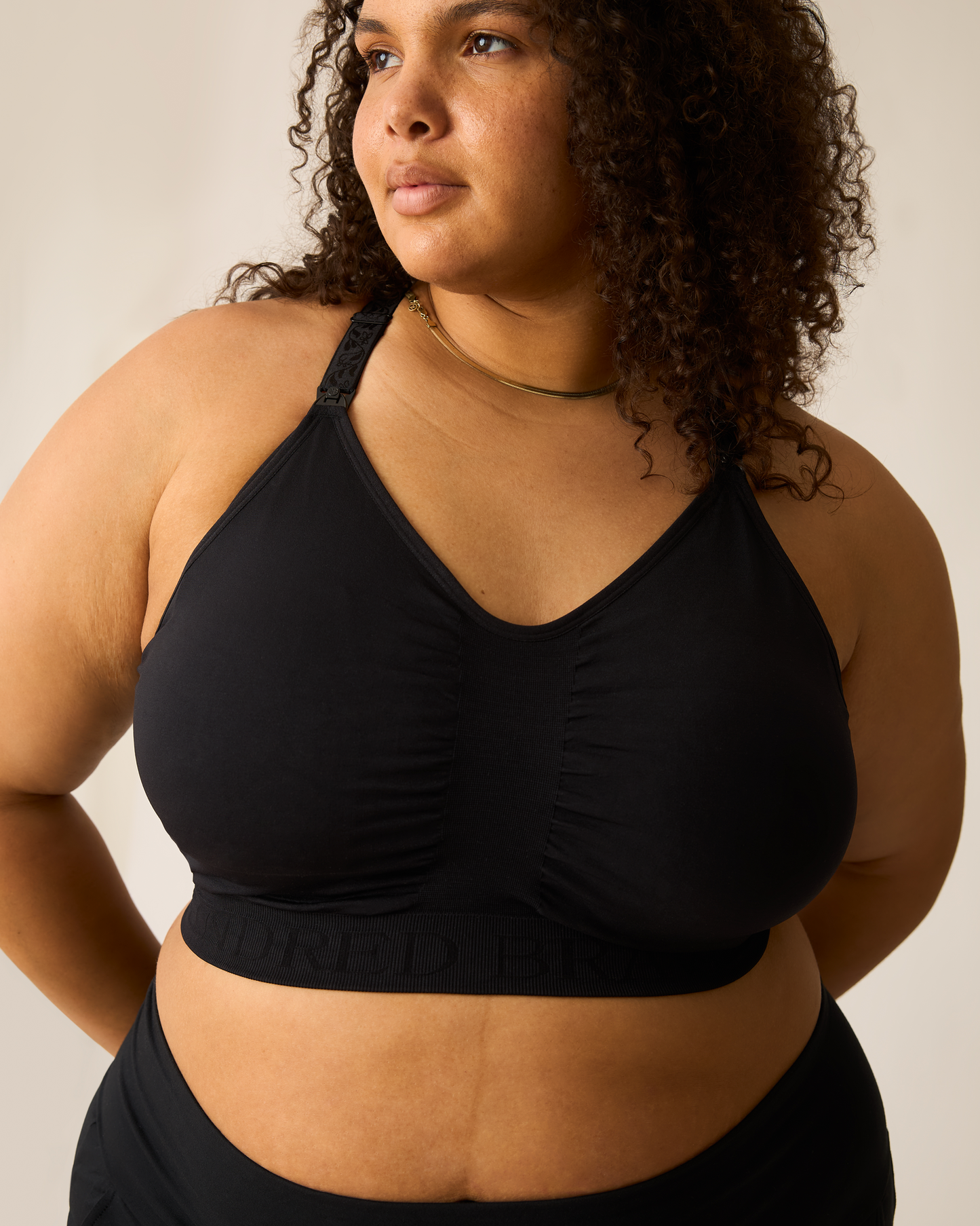 Woman wearing the Sublime® Nursing Sports Bra in black against a neutral background@model_info:Ionna is wearing a 1X Busty.