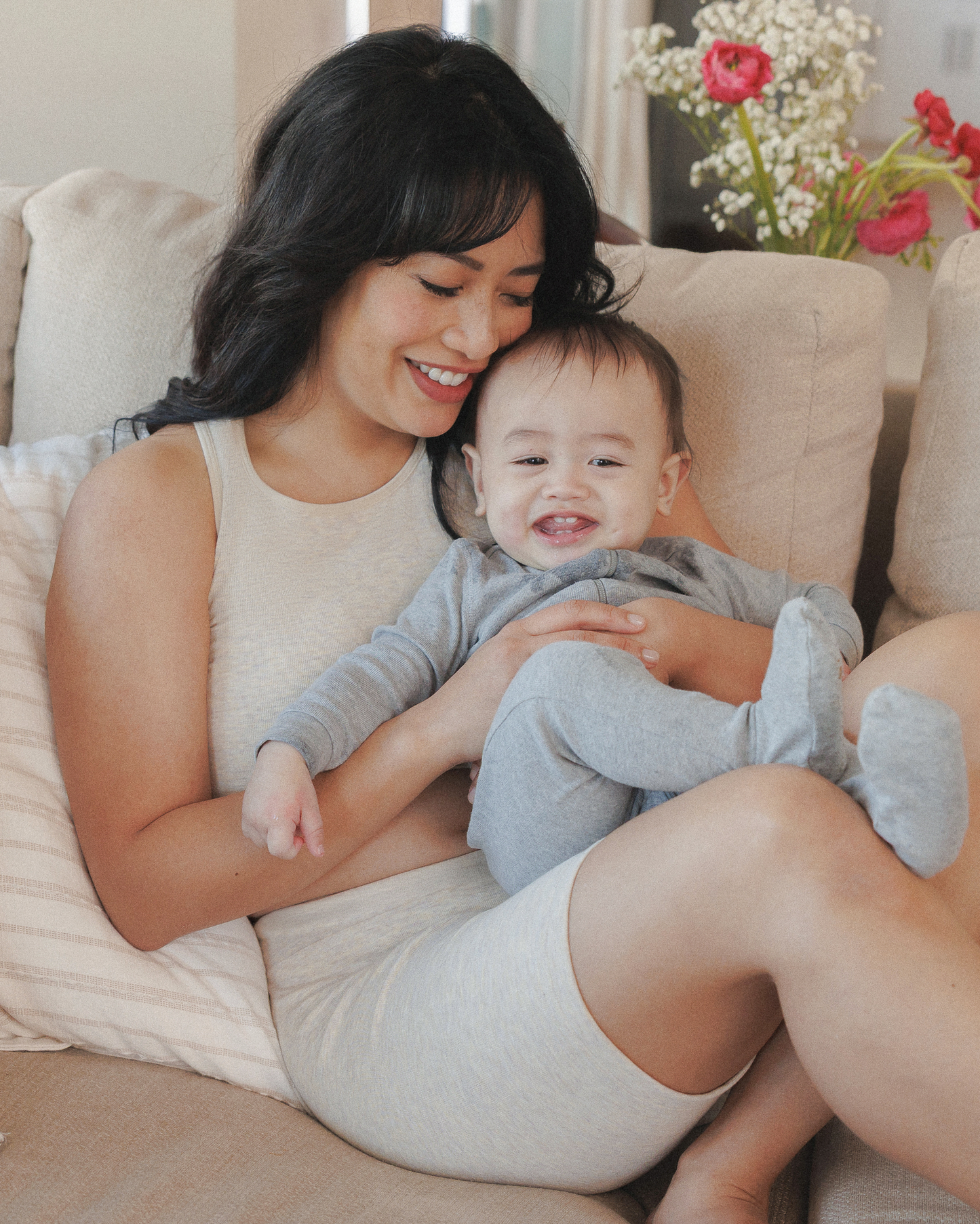 Model snuggling baby while wearing the Sublime® Bamboo Hands-Free Pumping Longline Bra Top in Oatmeal Heather 