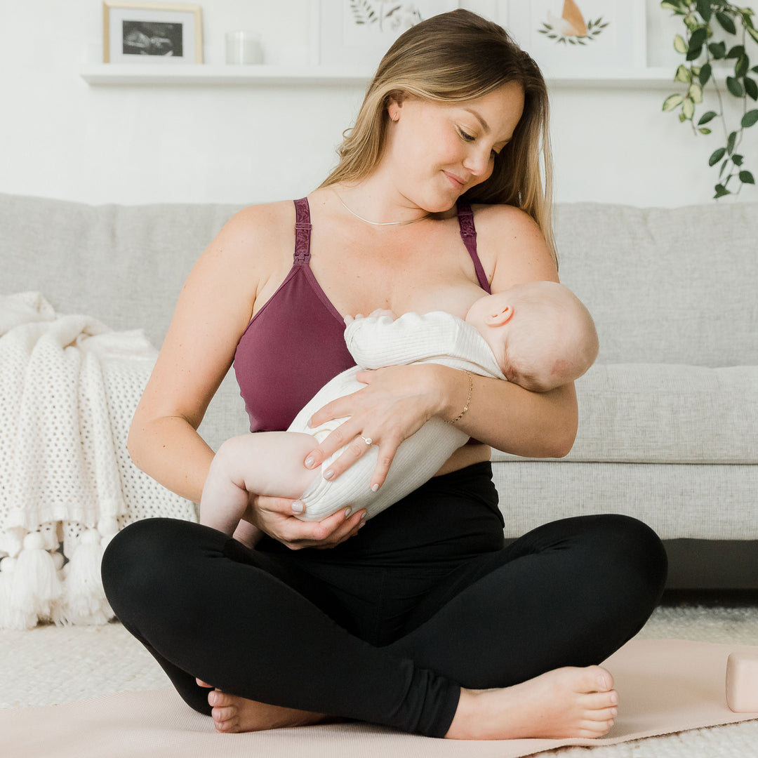 Model breastfeeding her baby while wearing the Sublime® Nursing Sports Bra | Fig @model_info:Ali is wearing a Large Busty.