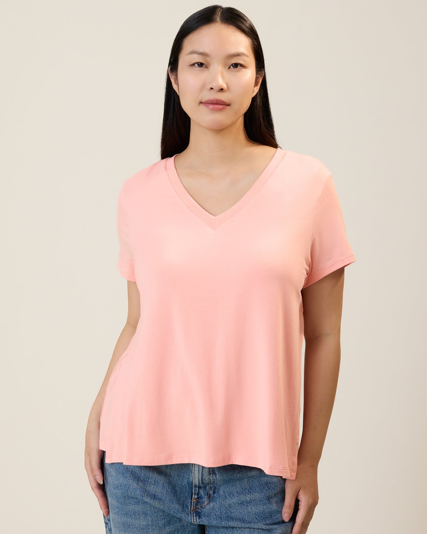 Front view of model wearing Classic Modal V-neck Nursing T-shirt in Sunset Pink on a neutral background@model_info:Cassie is wearing a Small.