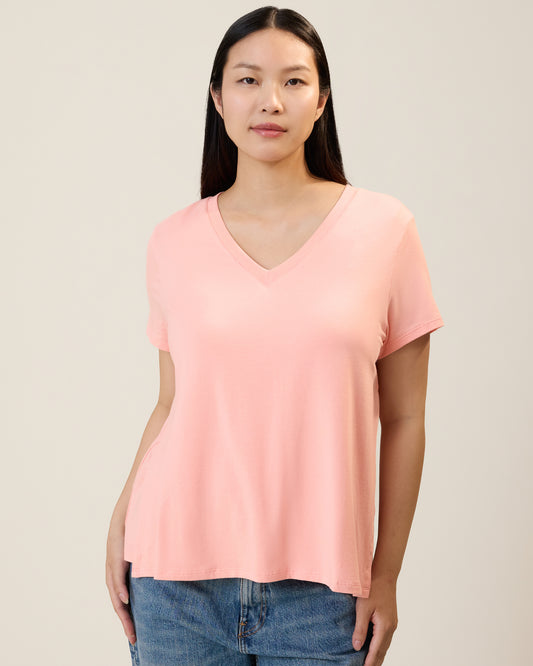 Front view of model wearing Classic Modal V-neck Nursing T-shirt in Sunset Pink on a neutral background@model_info:Cassie is wearing a Small.
