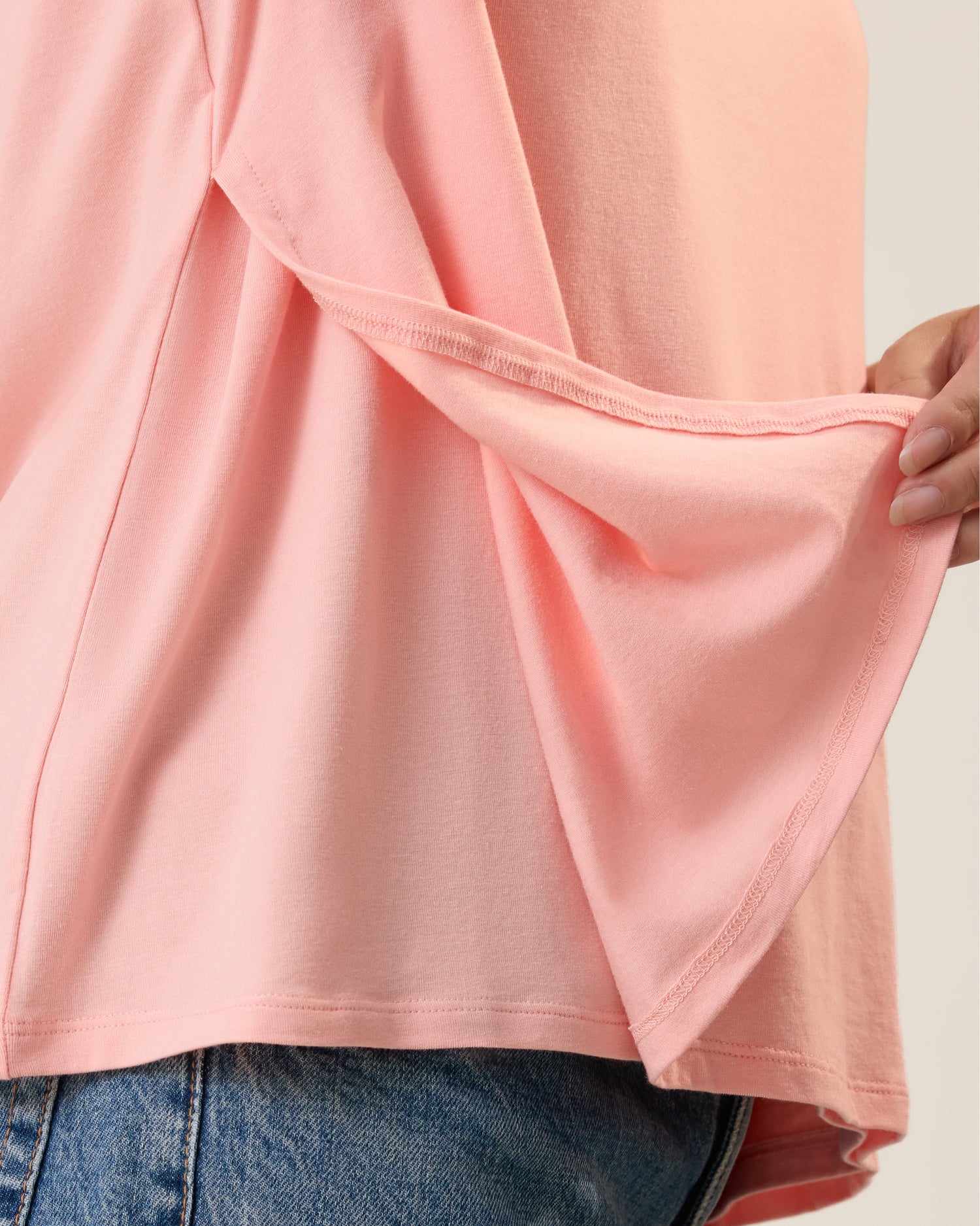 Front view of model wearing Classic Modal V-neck Nursing T-shirt in Sunset Pink showing the panel that provides the side access for nursing