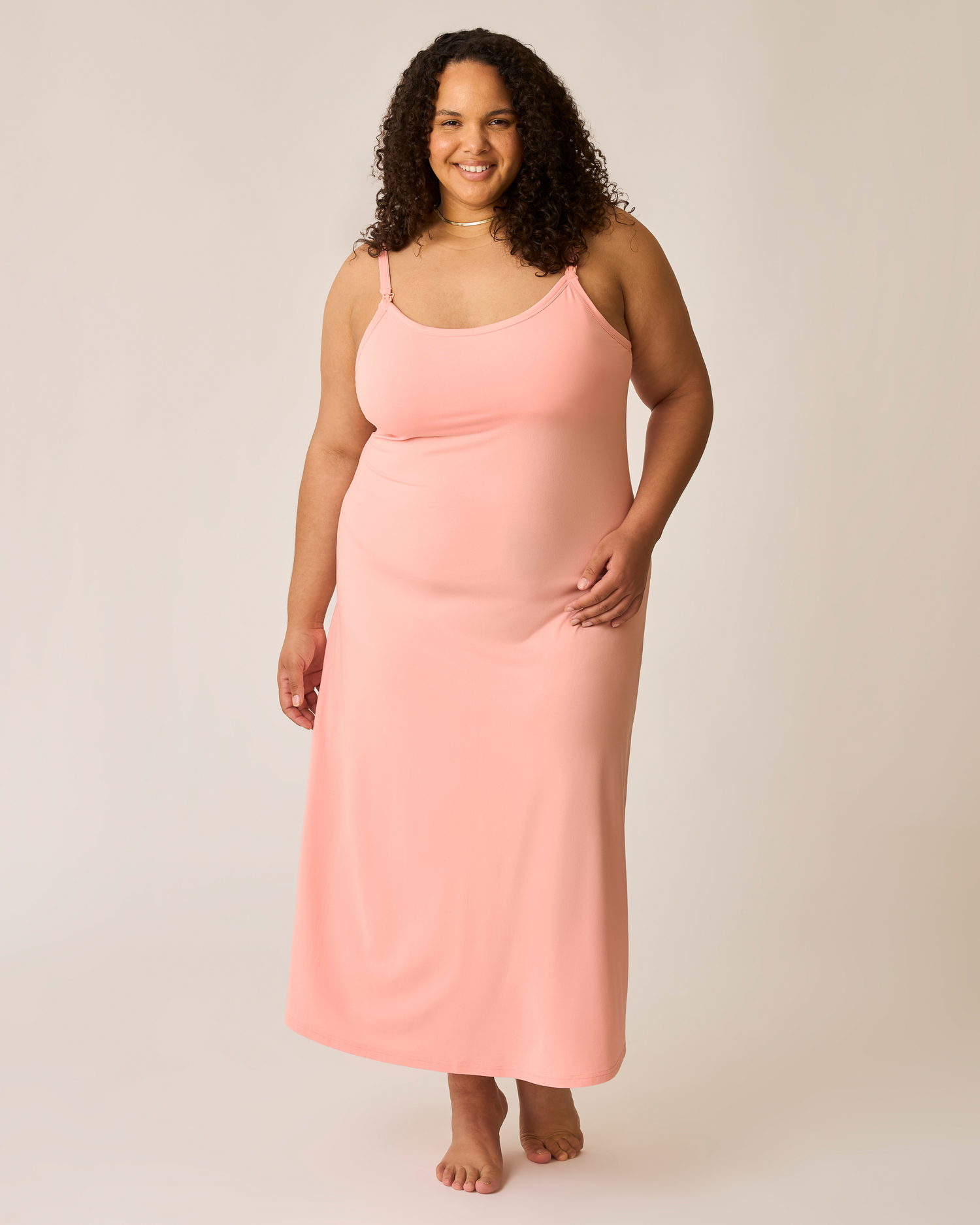 Woman wearing a pink nightgown against a plain background@model_info:Ionna is 5'11" and wearing a 2X.