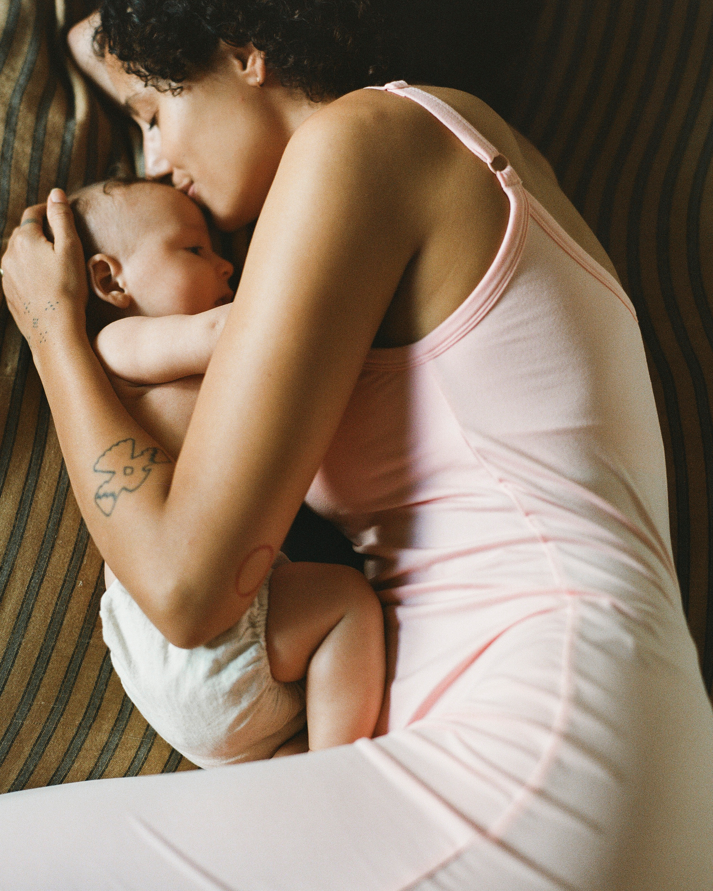 Woman in a pink nightgown holding a baby close @model_info:Natasha is 5'9" and wearing a Small.