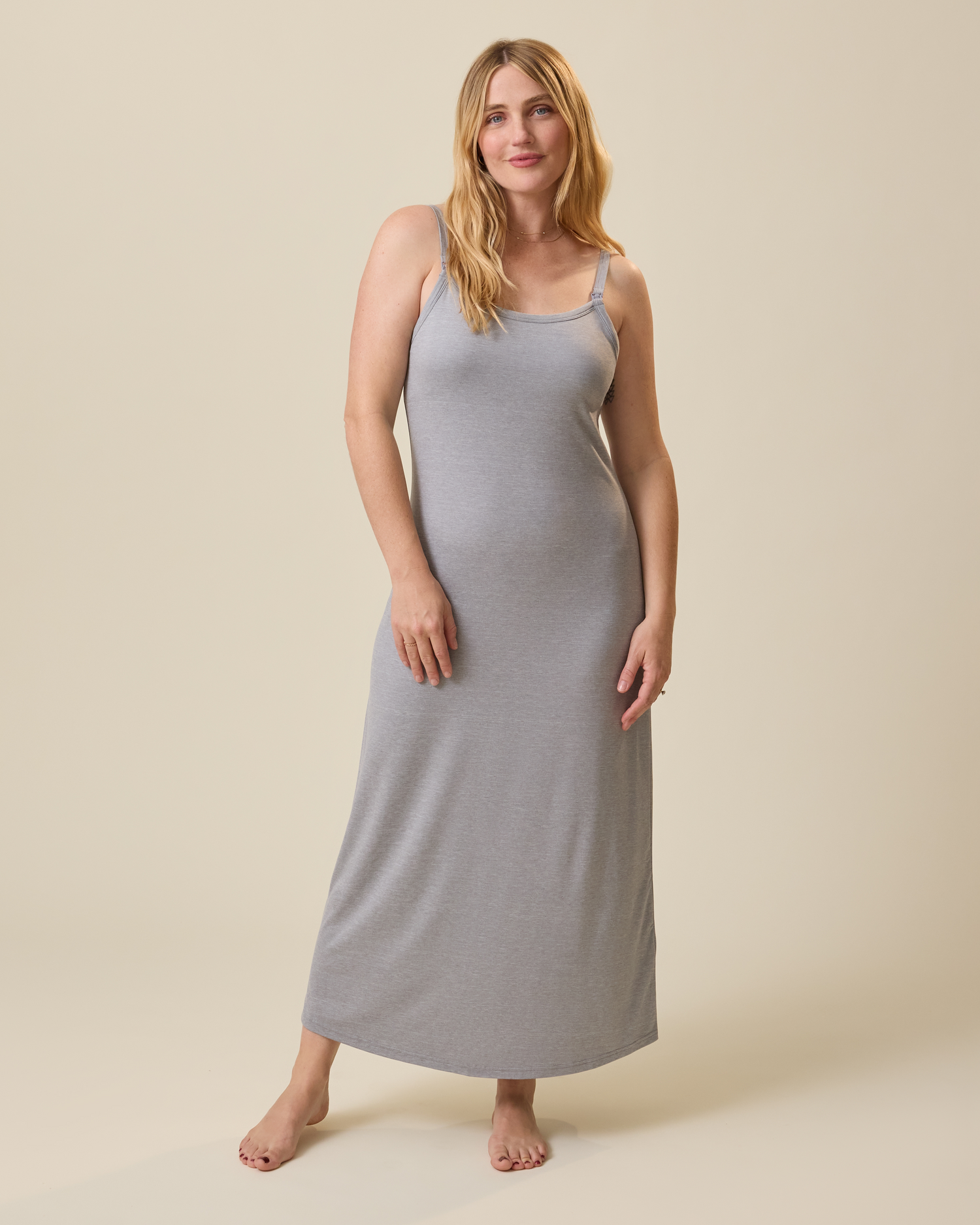 Woman wearing a gray sleeveless lounge dress against a beige background@model_info:Lauren is 5'8" and wearing a Medium.