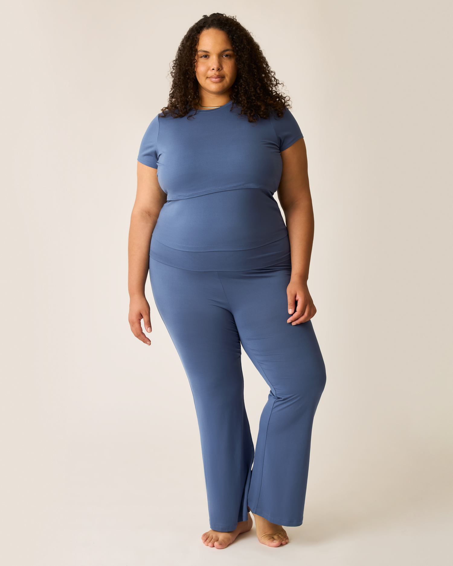 Woman wearing a blue lounge outfit on a plain background@model_info:Ionna is 5'11" and wearing a 2X
