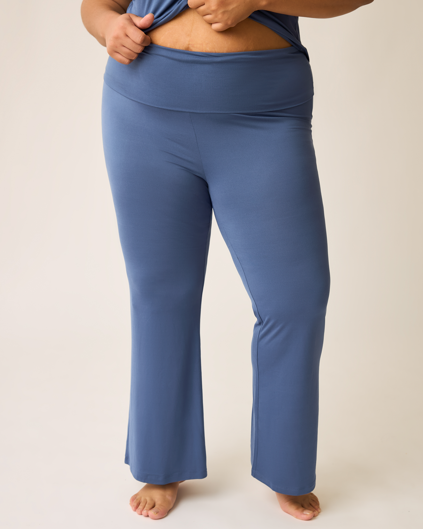 Person wearing blue lounge pants on a plain background