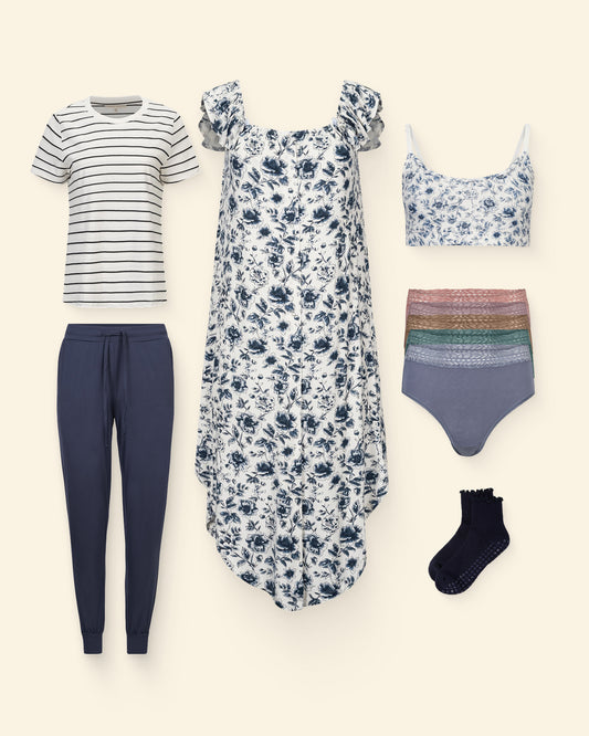 The Ultimate Labor & Delivery Bundle, consisting of Ruffle Labor & Delivery Gown,  Universal Labor & Delivery Gown, French Terry Racerback Nursing & Sleep Bra, French Terry Maternity & Nursing Bralette, a nursing tee of your choice, Ultralight Sleep & Lounge Jogger, High-Waisted Postpartum Recovery Underwear, and your choice of non-slip socks, on a beige background.