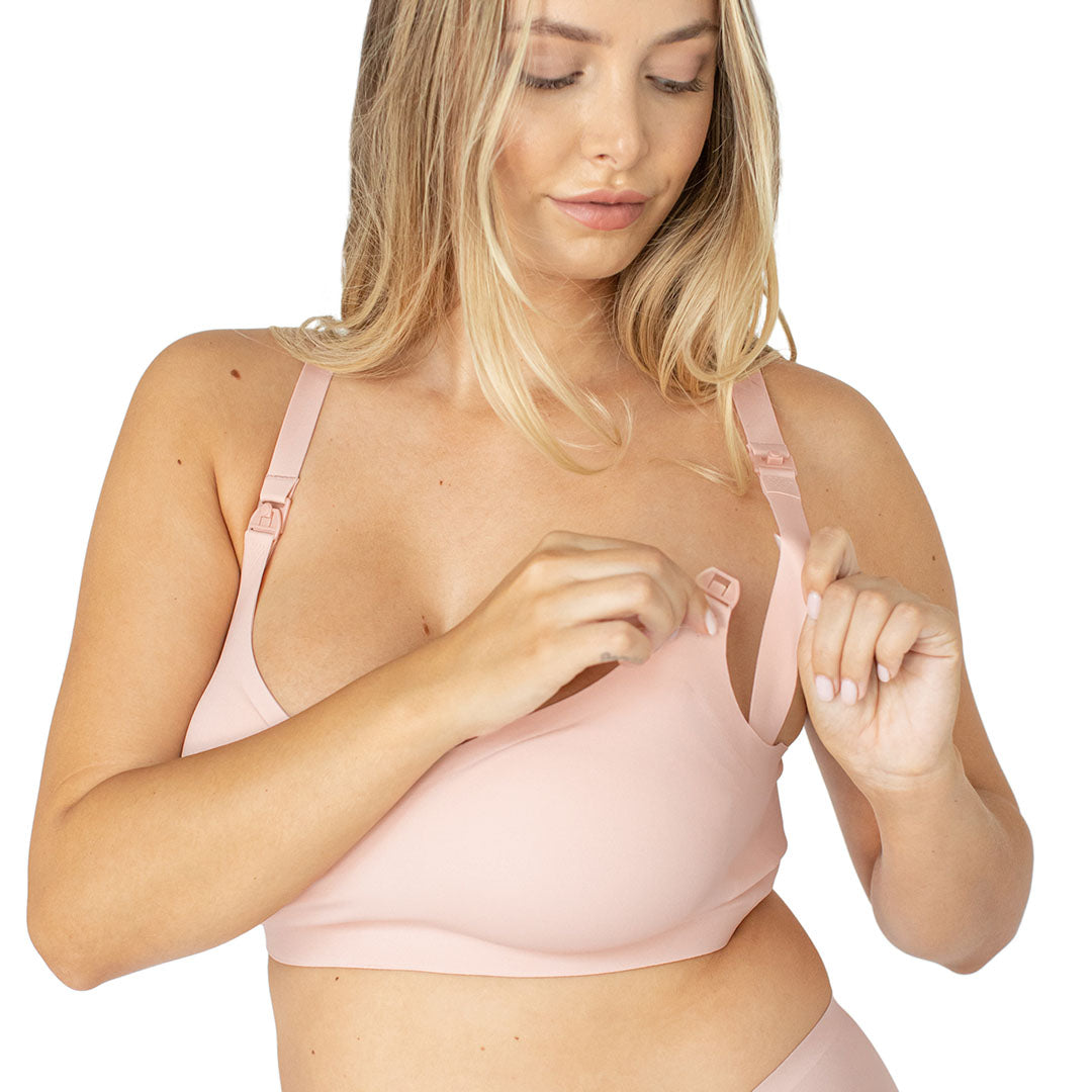 Model wearing the Ultra Comofrt Smooth Classic Nursing Bra in Soft Pink showing the clip down nursing access.