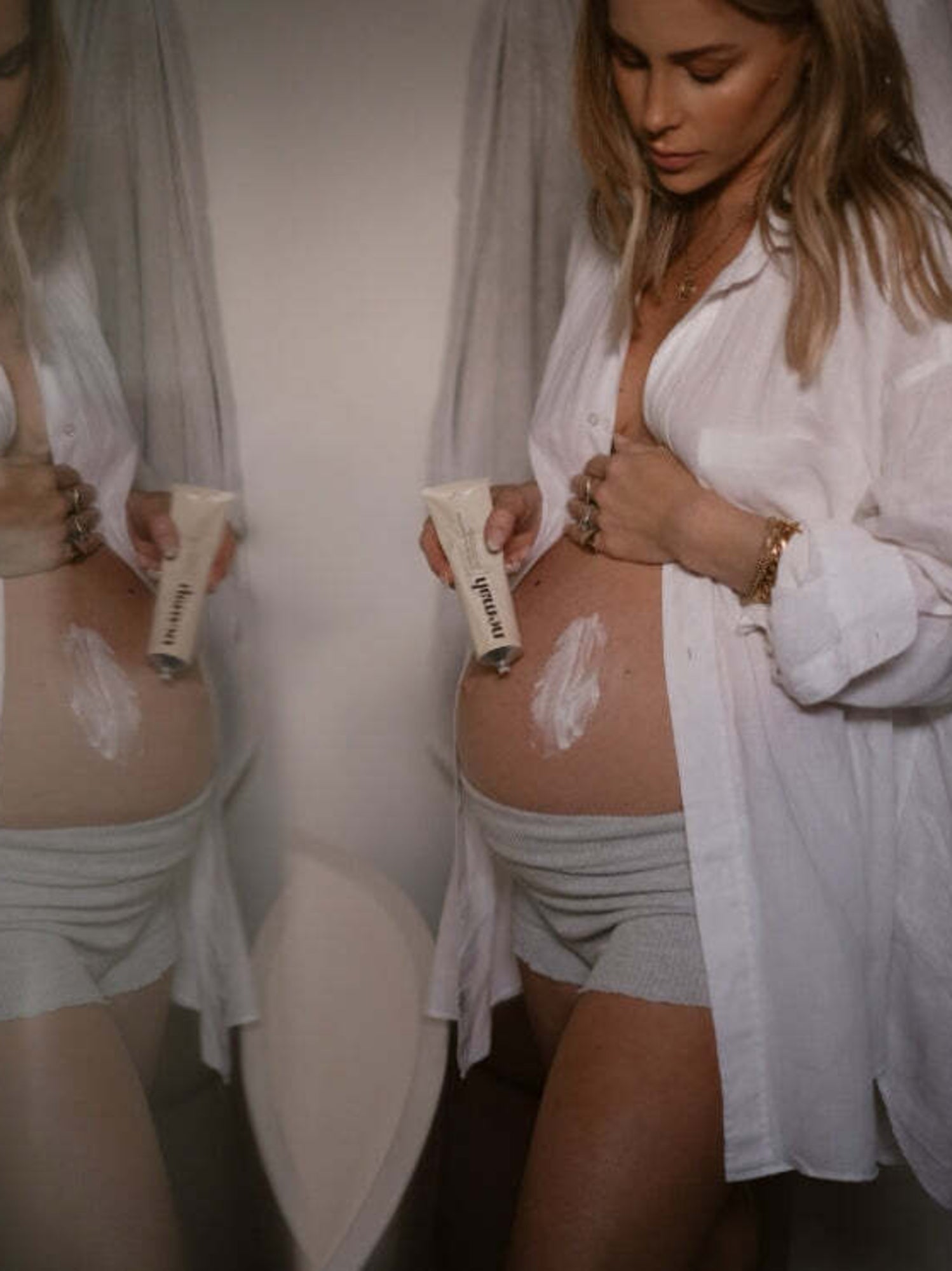 Model holding and applying Nēmah - Revitalizing Stretch Mark Cream | Kindred Bravely